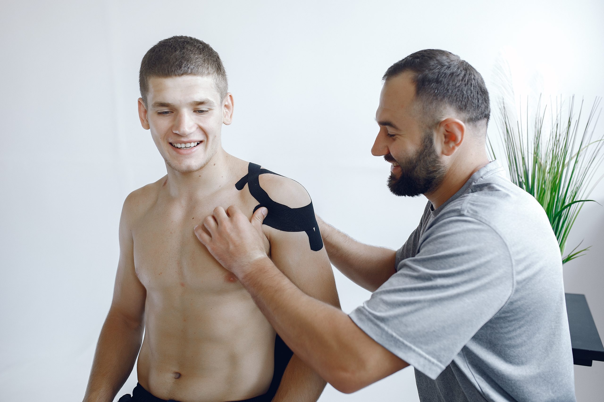 Kinesiology doctor. Sportsmen at the hospital. Man use the teppe